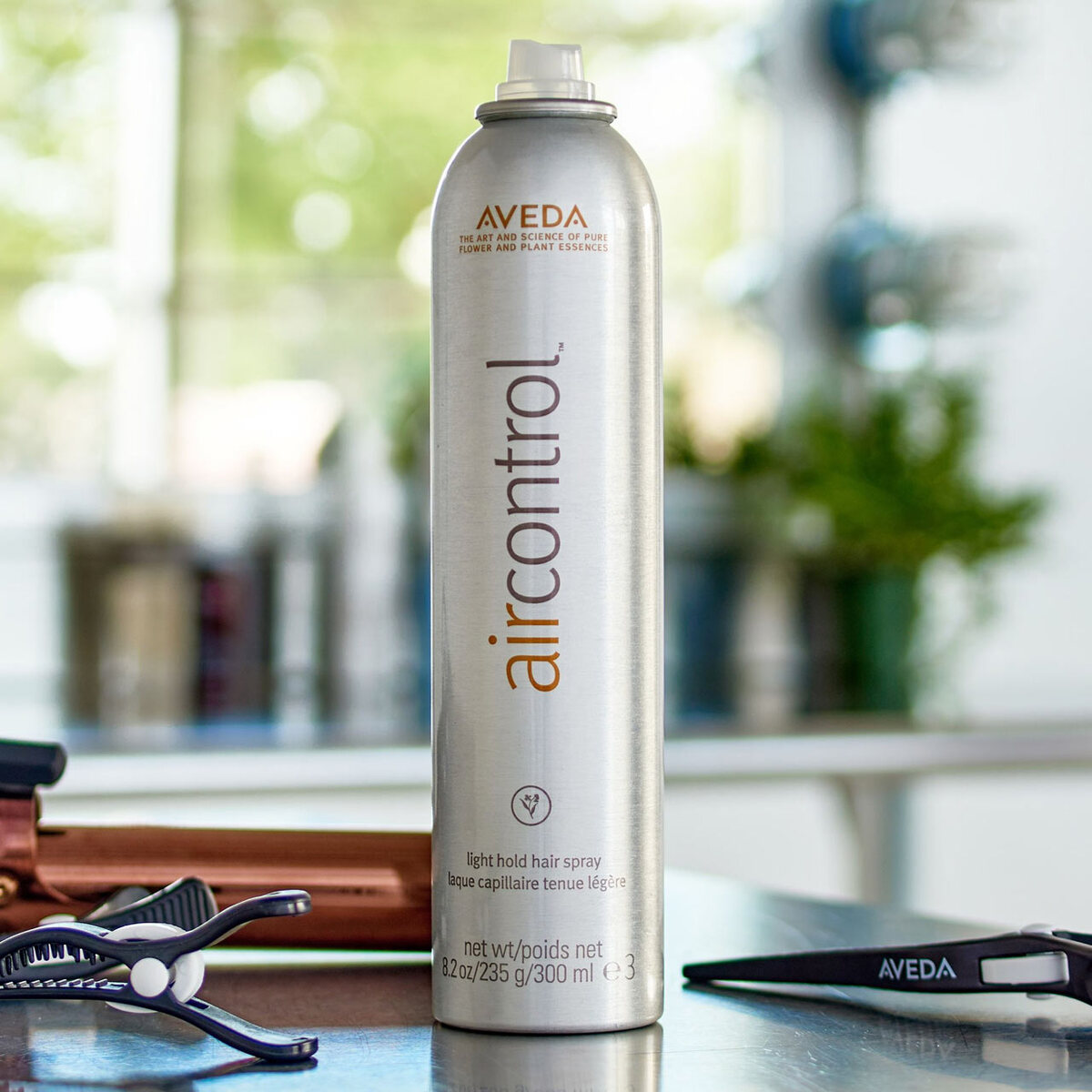 Aveda Air Control Light Hold Hair Spray can on a salon station